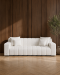 JOLIN Furniture Anella three-seater sofa with plush cushions and modern design in a cozy living room setting.